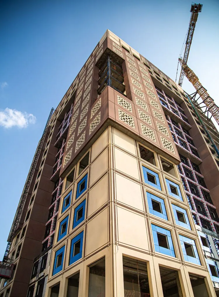 An Al Imdad tower rising against the Makkah skyline.